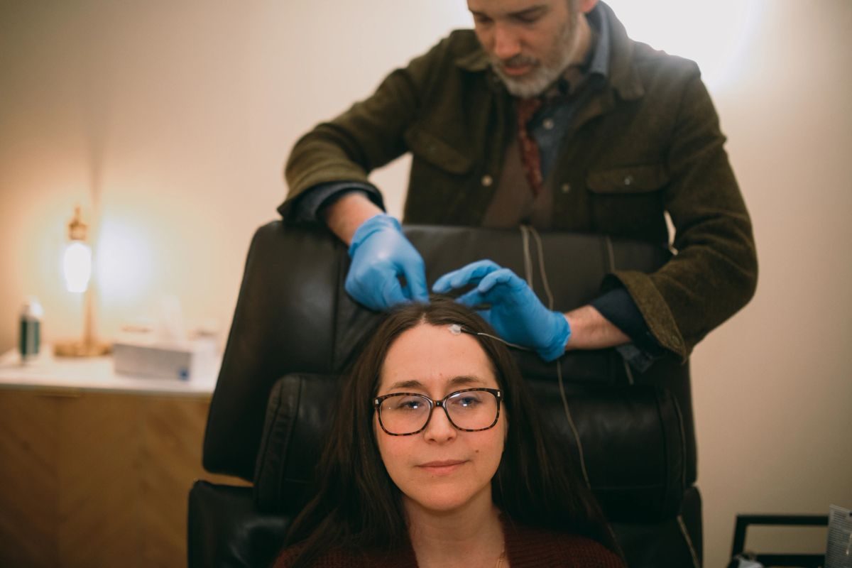 Clinician placing EEG sensors for a neurofeedback session