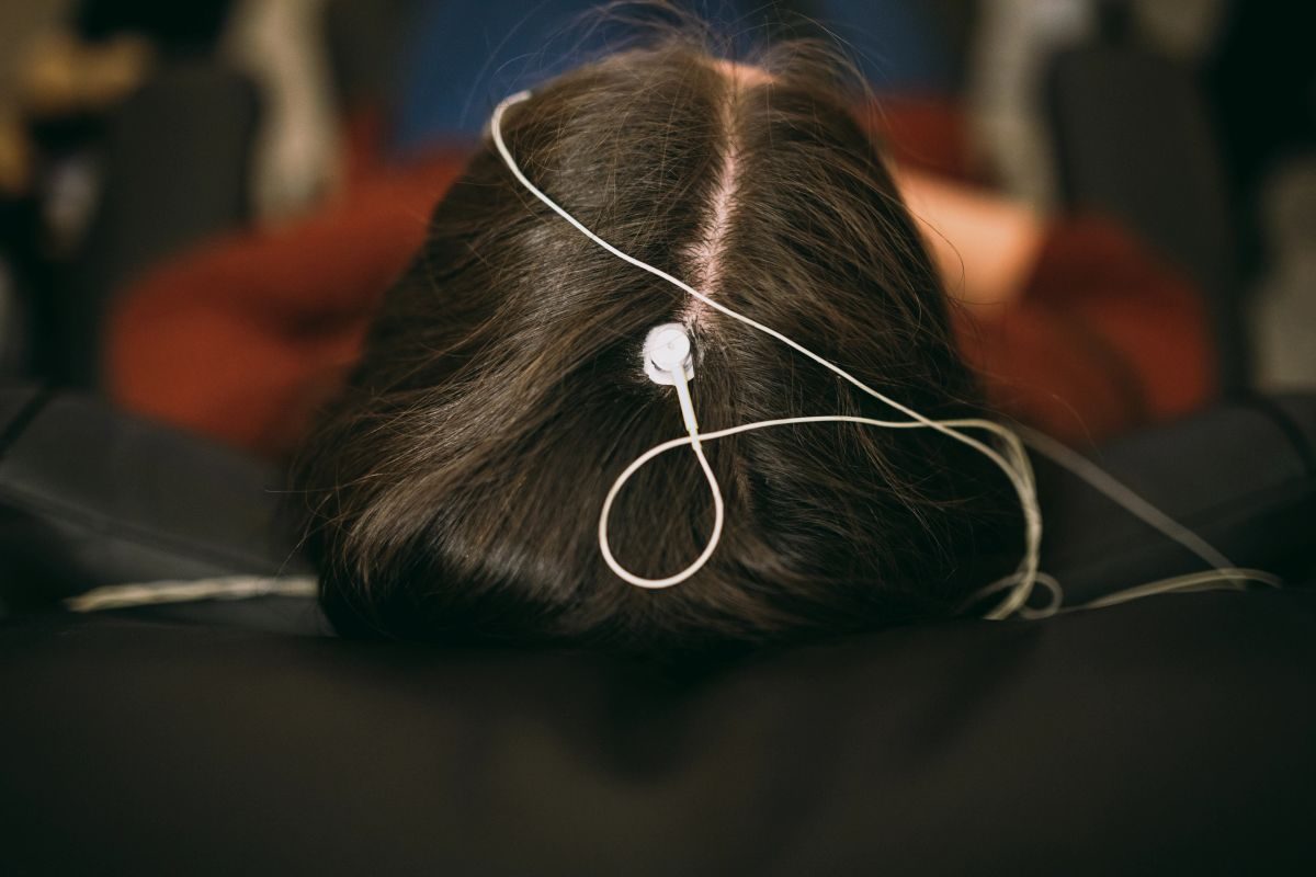 Close-up of a single EEG sensor placed on the scalp